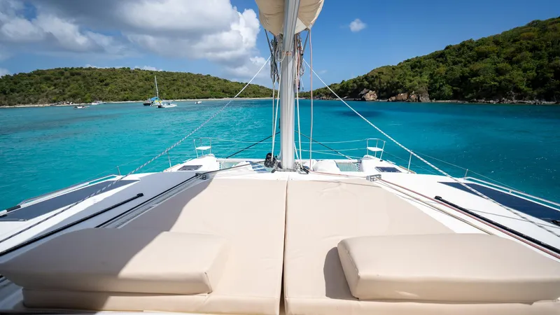 Altair Yacht Photos Pics Lagoon 450 F catamaran sailing in turquoise waters, 2018 model, with scenic island backdrop.