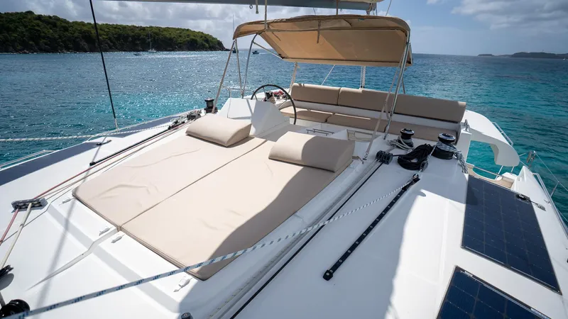 Altair Yacht Photos Pics Luxurious 2018 Lagoon 450 F catamaran with sunbathing area, sailing in clear blue waters.