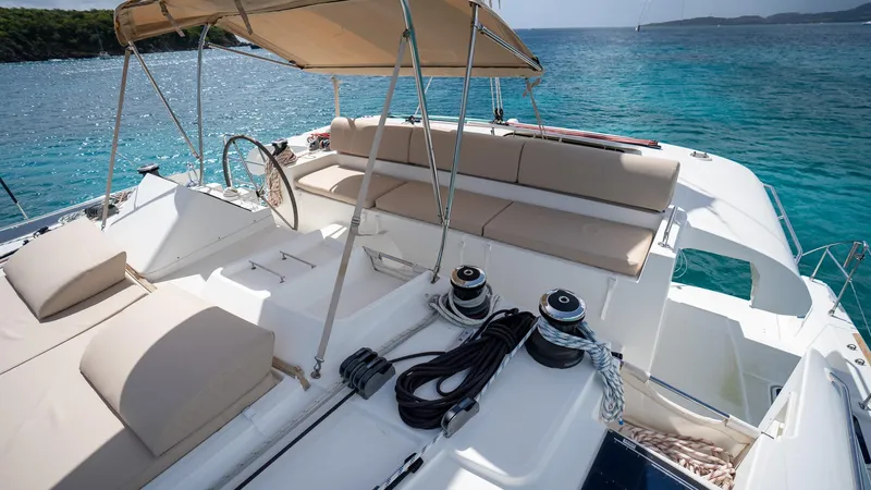 Altair Yacht Photos Pics Lagoon 450 F 2018 yacht with spacious deck and seating, overlooking clear blue waters.