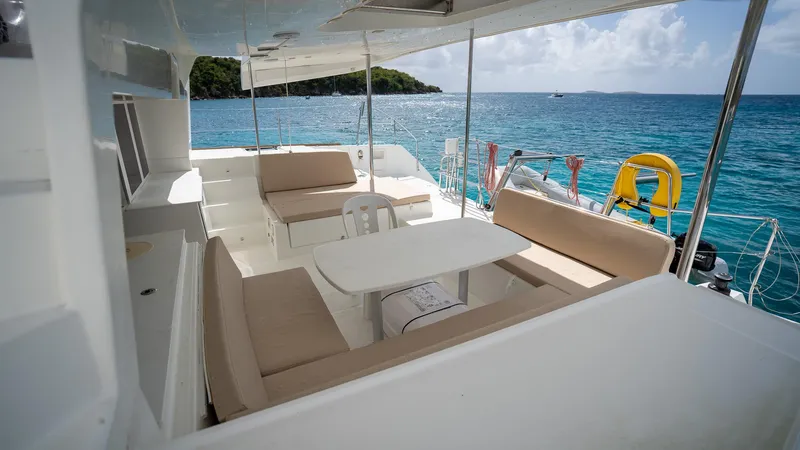 Altair Yacht Photos Pics Lagoon 450 F 2018 yacht deck with seating, table, and ocean view.