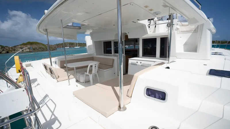 Altair Yacht Photos Pics 2018 Lagoon 450 F catamaran deck with seating, ocean view, and clear skies.