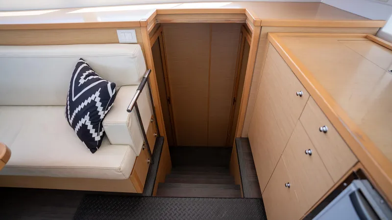Altair Yacht Photos Pics Interior of 2018 Lagoon 450 F yacht with stairs, seating, and cabinetry.