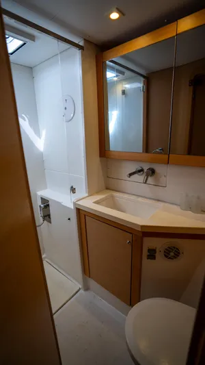 Altair Yacht Photos Pics Modern bathroom in 2018 Lagoon 450 F yacht with shower, sink, and mirror.