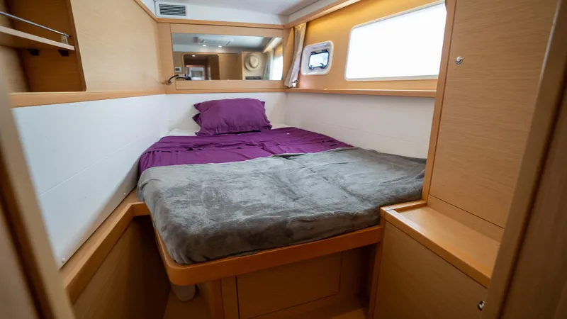Altair Yacht Photos Pics Cozy cabin interior of 2018 Lagoon 450 F catamaran with bed and window.