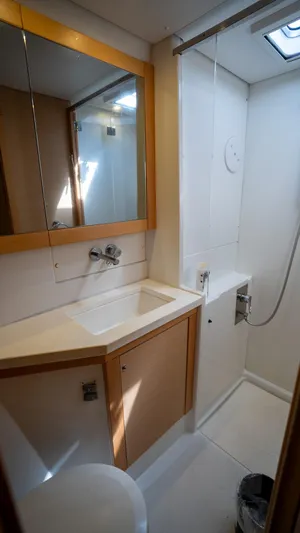 Altair Yacht Photos Pics Bathroom interior of 2018 Lagoon 450 F yacht, featuring modern fixtures and wooden cabinetry.