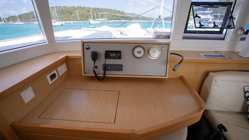 Altair Yacht Photos Pics Interior view of 2018 Lagoon 450 F yacht with navigation equipment and scenic ocean backdrop.