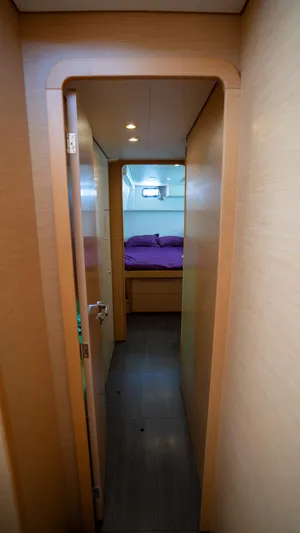 Altair Yacht Photos Pics Interior hallway of 2018 Lagoon 450 F yacht, leading to a cozy bedroom.