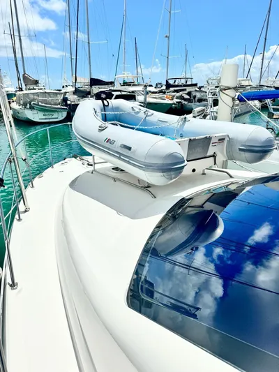  Yacht Photos Pics 2007 Sea Ray 44 Sedan Bridge yacht with inflatable dinghy on deck, docked at marina.