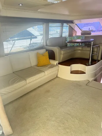  Yacht Photos Pics Interior of 2007 Sea Ray 44 Sedan Bridge with beige seating and dining area.