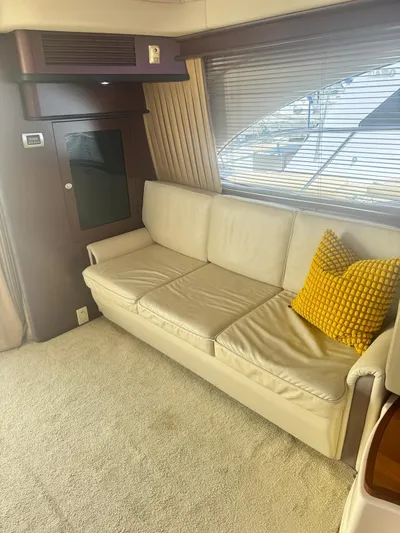  Yacht Photos Pics Interior of 2007 Sea Ray 44 Sedan Bridge with beige sofa and yellow pillow.