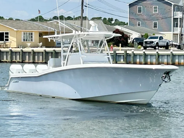  Yacht Photos Pics 2018 Invincible 36 Open boat cruising near a dock.