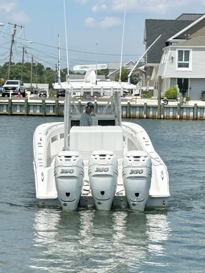  Yacht Photos Pics 2018 Invincible 36 Open boat with triple outboard engines on the water.