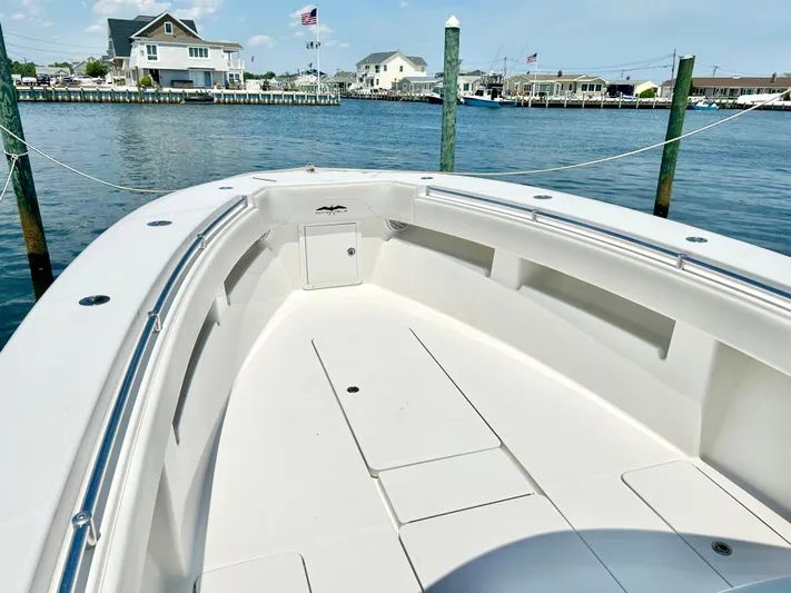  Yacht Photos Pics 2018 Invincible 36 Open boat docked in a scenic waterfront marina.