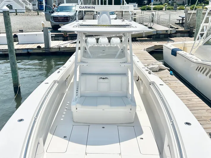  Yacht Photos Pics 2018 Invincible 36 Open boat docked at marina, featuring spacious deck and advanced Garmin navigation.
