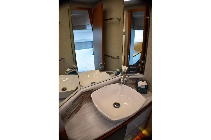  Yacht Photos Pics Luxurious bathroom interior of 2019 Tiara Yachts C49 Coupe with modern sink and mirror.