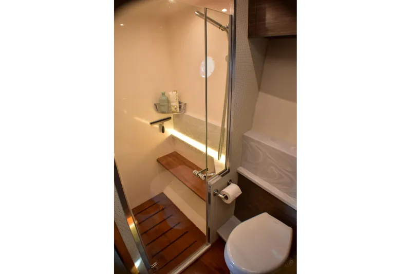  Yacht Photos Pics Luxurious bathroom in 2019 Tiara Yachts C49 Coupe with modern shower and wooden accents.