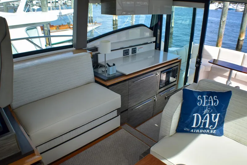  Yacht Photos Pics 2019 Tiara Yachts C49 Coupe interior with modern seating and nautical decor.