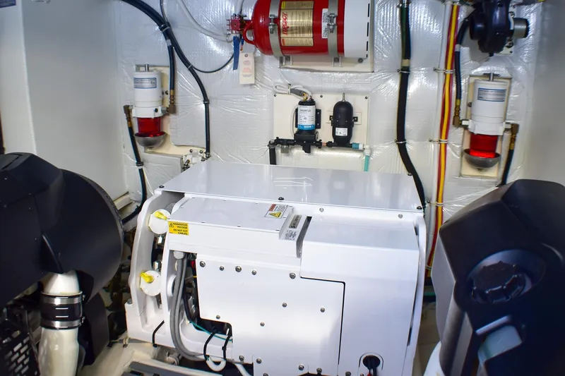  Yacht Photos Pics Engine room of 2019 Tiara Yachts C49 Coupe, featuring modern equipment and fire suppression system.