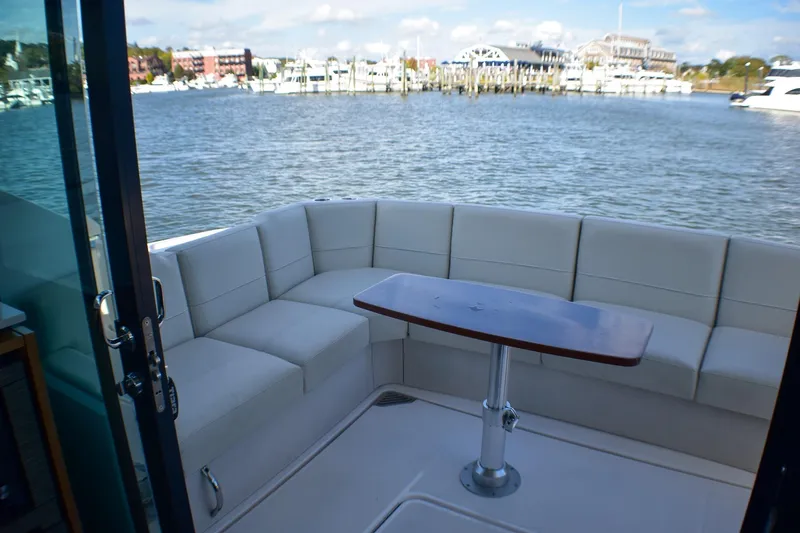  Yacht Photos Pics 2019 Tiara Yachts C49 Coupe with elegant seating and scenic waterfront view.