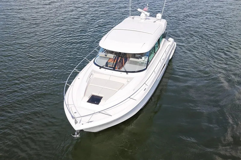  Yacht Photos Pics 2019 Tiara Yachts C49 Coupe cruising on open water, aerial view.