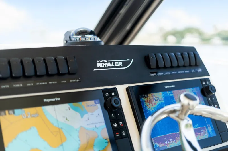  Yacht Photos Pics 2021 Boston Whaler 325 Conquest dashboard with navigation screens and controls.