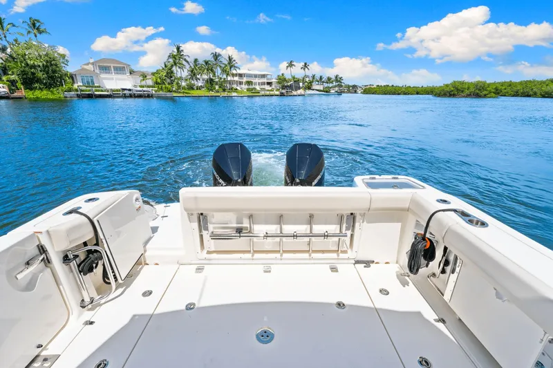  Yacht Photos Pics Boston Whaler 325 Conquest 2021 on serene water with clear blue sky.