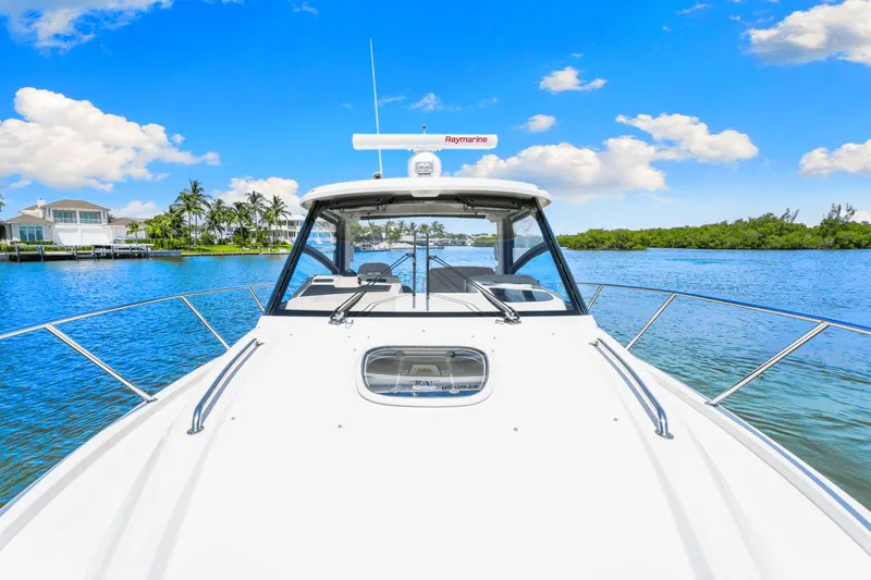  Yacht Photos Pics 2021 Boston Whaler 325 Conquest on serene blue water under clear sky.