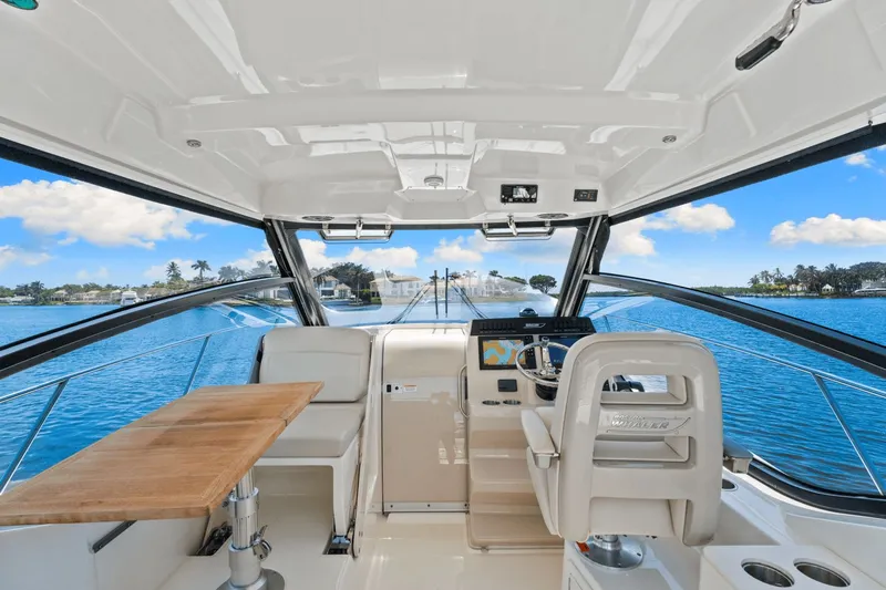  Yacht Photos Pics 2021 Boston Whaler 325 Conquest interior with helm, seating, and ocean view.