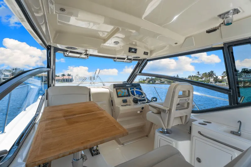  Yacht Photos Pics Interior of 2021 Boston Whaler 325 Conquest boat with helm and seating area.