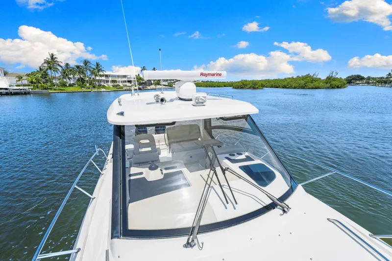  Yacht Photos Pics 2021 Boston Whaler 325 Conquest on serene water with clear blue sky.