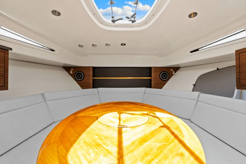  Yacht Photos Pics Interior of 2021 Boston Whaler 325 Conquest, featuring a cozy seating area and skylight.