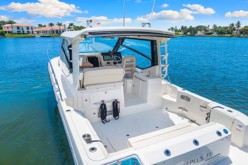  Yacht Photos Pics 2021 Boston Whaler 325 Conquest boat on serene blue water, Naples, FL.