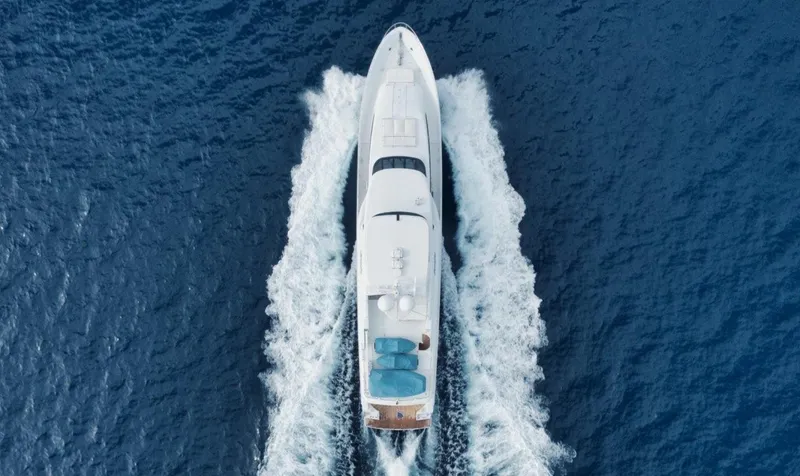 Island Girl Yacht Photos Pics Aerial view of 2002 Westport 112 yacht cruising on blue ocean waters.