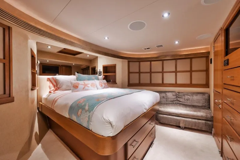 Island Girl Yacht Photos Pics Luxurious bedroom interior of 2002 Westport 112 yacht with cozy bed and elegant decor.