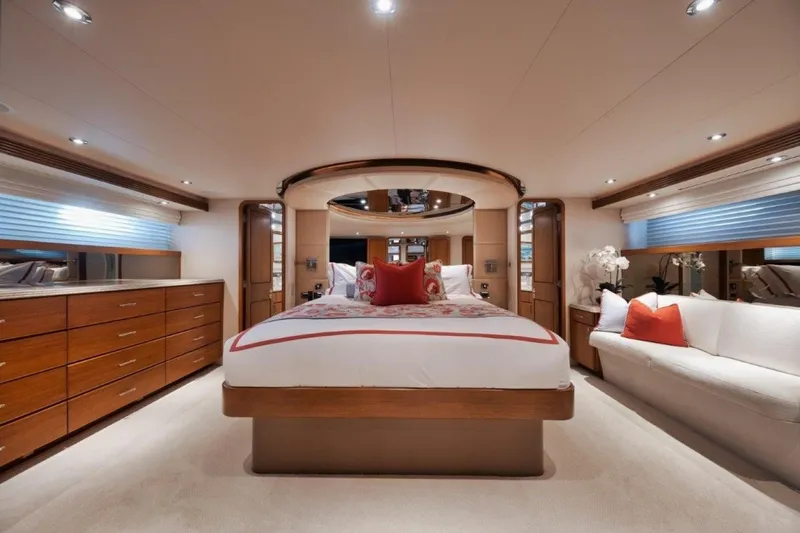 Island Girl Yacht Photos Pics Luxurious bedroom interior of 2002 Westport 112 yacht with elegant furnishings and ambient lighting.