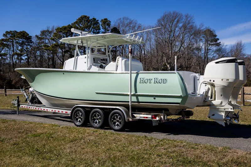 Hot Rod Yacht Photos Pics 2005 French Yachts 34 Center Console on trailer, parked outdoors.