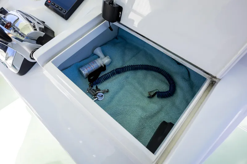 Hot Rod Yacht Photos Pics Storage compartment on a 2005 French Yachts 34 Center Console boat with coiled cable.