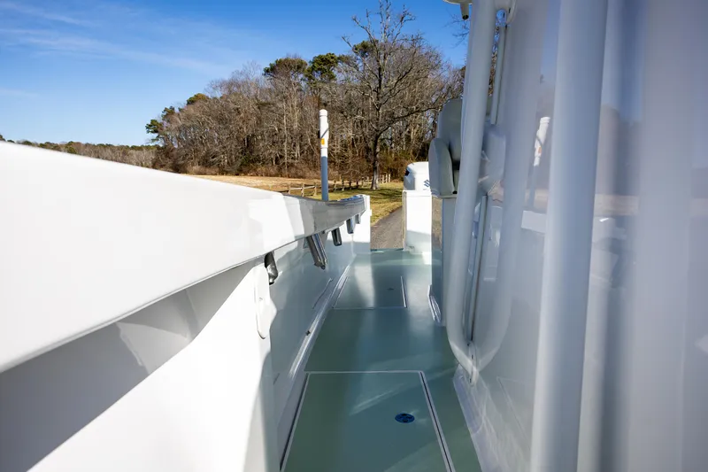 Hot Rod Yacht Photos Pics 2005 French Yachts 34 Center Console, side view, docked near wooded shoreline.