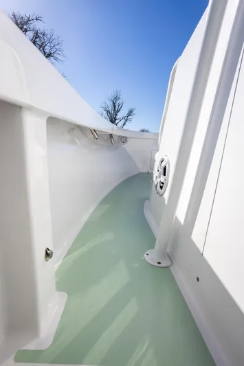 Hot Rod Yacht Photos Pics 2005 French Yachts 34 Center Console, sleek white deck, clear blue sky background.