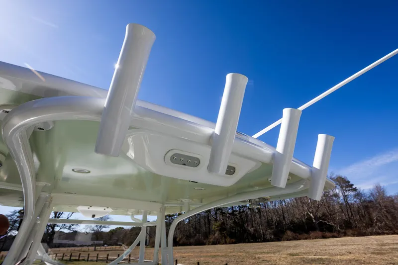 Hot Rod Yacht Photos Pics 2005 French Yachts 34 Center Console, rod holders, clear sky background.