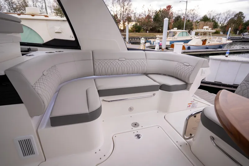 Nauti Tiger Yacht Photos Pics 2024 Sea Ray Sundancer 370 yacht interior with elegant seating at a marina.