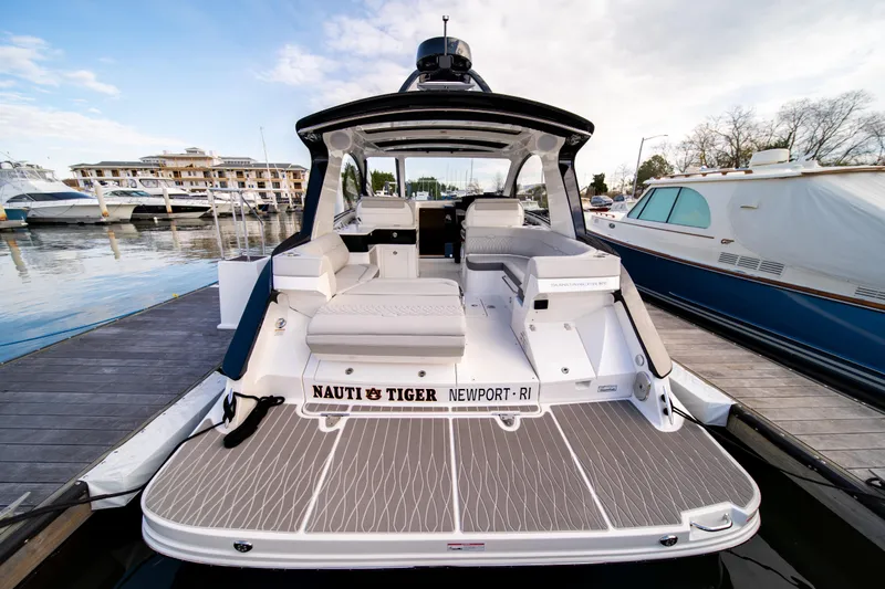 Nauti Tiger Yacht Photos Pics 2024 Sea Ray Sundancer 370 yacht docked, showcasing spacious deck and luxurious seating.
