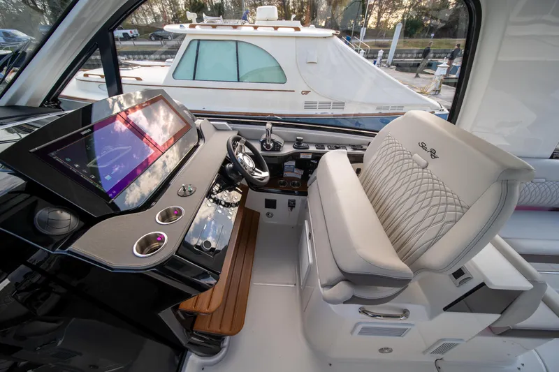 Nauti Tiger Yacht Photos Pics 2024 Sea Ray Sundancer 370 helm with modern controls and luxurious seating.