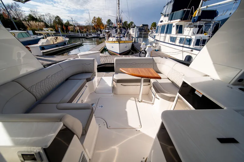 Nauti Tiger Yacht Photos Pics Luxurious 2024 Sea Ray Sundancer 370 yacht interior with elegant seating and wooden table.