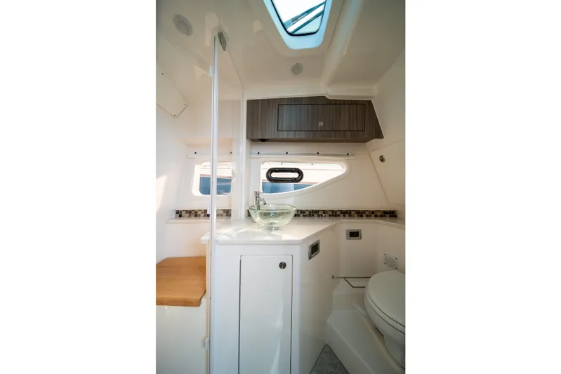 Nauti Tiger Yacht Photos Pics 2024 Sea Ray Sundancer 370 interior bathroom with modern design and glass sink.