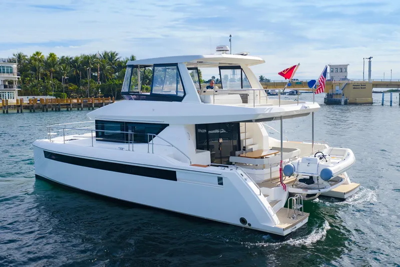 Better Now Yacht Photos Pics 2023 Leopard 46 Powercat yacht cruising on a sunny day near a tropical shoreline.
