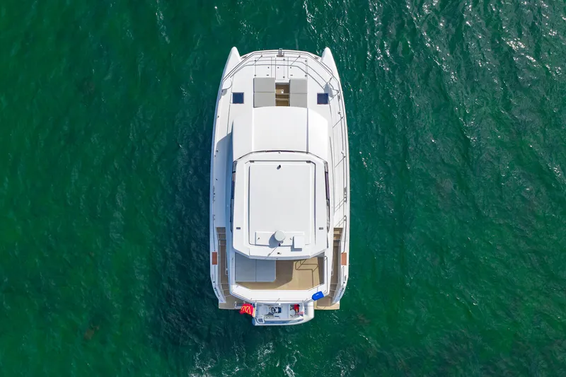 Better Now Yacht Photos Pics Aerial view of 2023 Leopard 46 Powercat yacht on green ocean water.