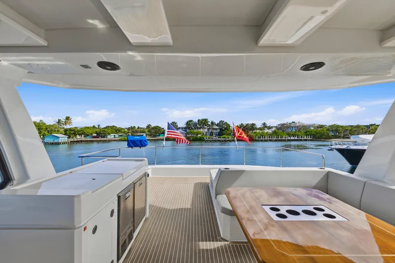 Better Now Yacht Photos Pics 2023 Leopard 46 Powercat yacht deck with scenic waterfront view.