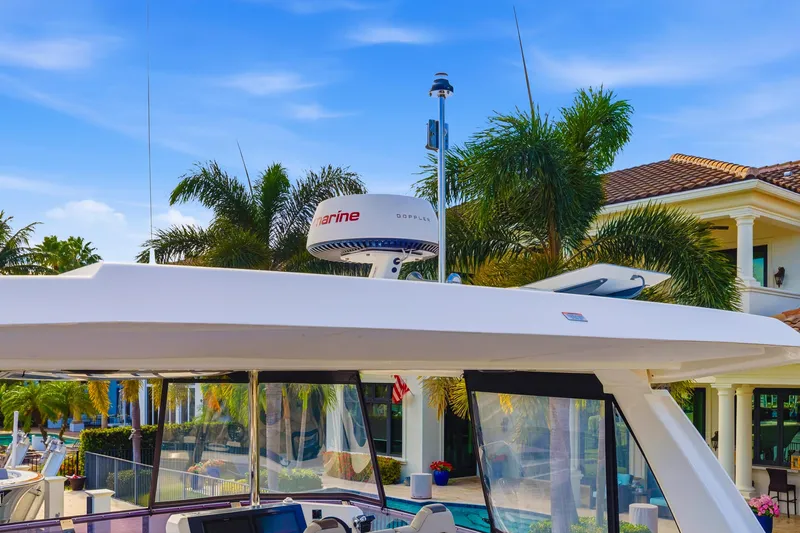 Better Now Yacht Photos Pics 2023 Leopard 46 Powercat yacht with radar, docked near tropical villa.