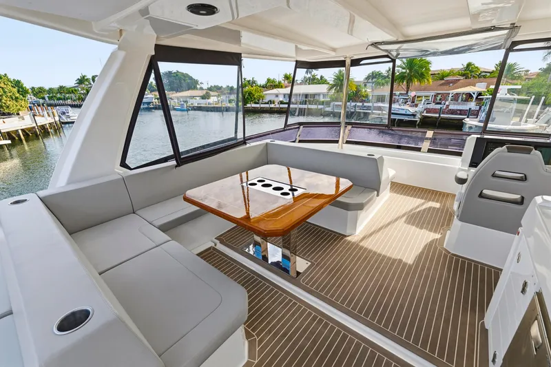 Better Now Yacht Photos Pics Luxurious interior of 2023 Leopard 46 Powercat yacht with spacious seating and elegant table.